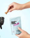 Dog and Hand Holding Stand-Up Pouch Mockup