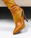 Pair of Over-The-Knee Boots on Women's Legs on Sofa Mockup
