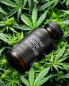 Amber Supplements Bottle on a Hemp Leaves Mockup