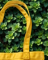 Tote Bag on a Leafy Greens Background Mockup