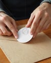 Round Sticker in a Hands Mockup
