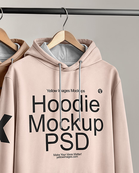 Two Hoodies on a Wooden Hanger Against a Plain Background Mockup