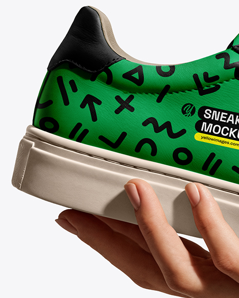 Woman's Hand Holding Sneaker Mockup