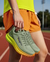 Pair of Running Shoes in Woman's Hand Mockup