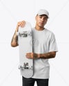 Young Man Wearing T-Shirt and Holding Skateboard Mockup
