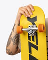 Young Man Wearing T-Shirt and Holding Skateboard Mockup