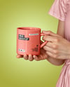 Woman Holding Glossy Mug in a Hands Mockup