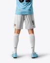 Man Wearing Soccer Jersey and Shorts Mockup