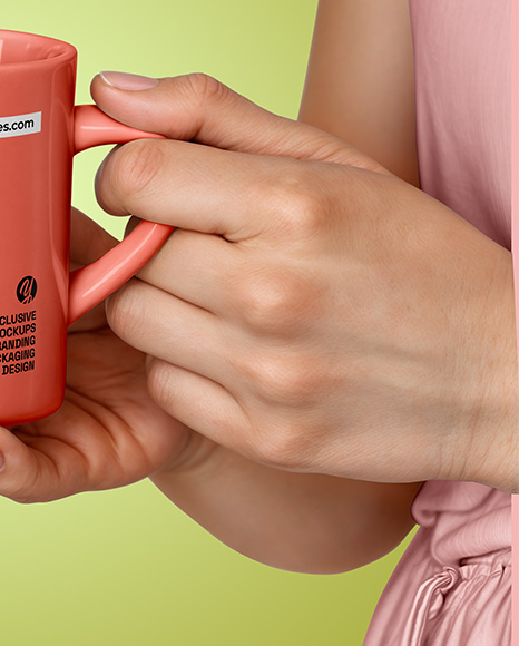 Woman Holding Glossy Mug in a Hands Mockup