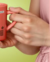 Woman Holding Glossy Mug in a Hands Mockup