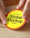 Round Sticker in a Hands Mockup