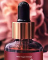 Amber Dropper Bottle with Oil Tincture Surrounded by Flowers Mockup