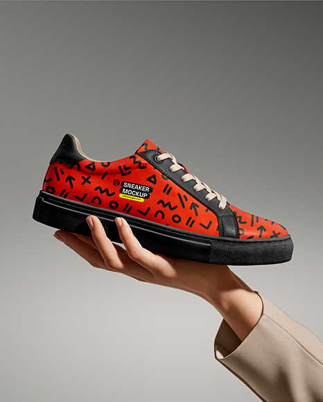 Woman's Hand Holding Sneaker Mockup