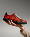 Woman's Hand Holding Sneaker Mockup