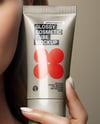 Woman Holding Glossy Cosmetic Tube in a Hand Mockup