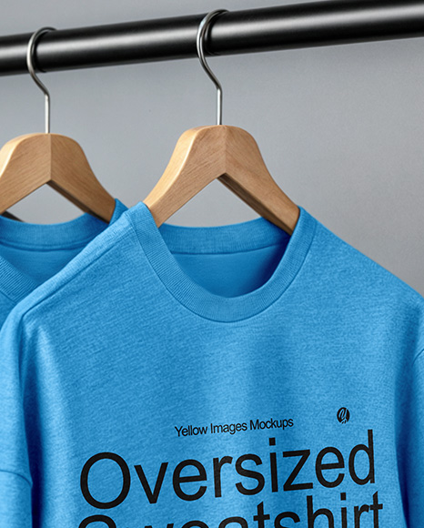 Five Sweatshirts on a Black Rack Against a Plain Background Mockup