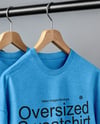 Five Sweatshirts on a Black Rack Against a Plain Background Mockup