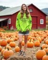 Young Woman in Sweatshirt Standing on Hay Block with Pumpkins Around Mockup