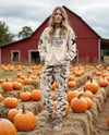 Young Woman in Sweatshirt and Joggers Standing on Hay Block at Pumpkin Patch Mockup