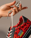 Woman's Hands Holding Sneaker Mockup