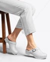 Pair of Clogs on Woman's Legs Sitting on Stool Mockup
