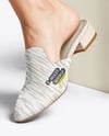 Pair of Suede Mules on Woman's Legs with Skirt Mockup