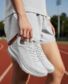 Pair of Running Shoes in Woman's Hand Mockup