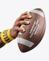 American Football Ball in a Hand Mockup