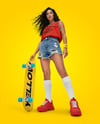 Woman Wearing Sleeveless Shirt and Jean Shorts with Skateboard Mockup