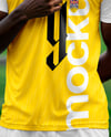 Soccer Player Wearing a Crew Neck Jersey and Shorts at the Stadium Mockup