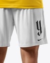 Man Wearing Soccer Jersey and Shorts Mockup