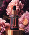 Amber Dropper Bottle with Oil Tincture Surrounded by Flowers Mockup