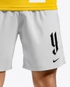 Man Wearing Soccer Jersey and Shorts Mockup