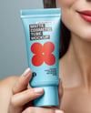 Woman Holding Matte Cosmetic Tube in a Hand Mockup