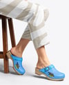 Pair of Clogs on Woman's Legs Sitting on Stool Mockup