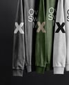 Three Sweatshirts on a Black Rack Against a Plain Background Mockup