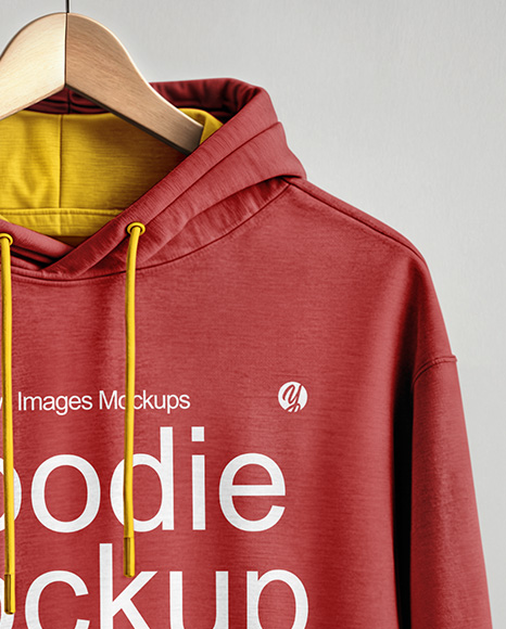 Hoodie on a Wooden Hanger Against a Plain Background Mockup