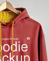 Hoodie on a Wooden Hanger Against a Plain Background Mockup