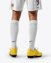 Man Wearing Soccer Jersey and Shorts Mockup