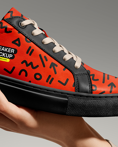 Woman's Hand Holding Sneaker Mockup
