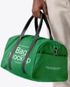 Man Wearing T-Shirt and Sweatpants Holding Duffle Bag Mockup