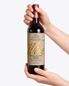 Red Wine Bottle in Hands Mockup