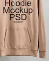 Hoodie on a Wooden Hanger Against a Plain Background Mockup