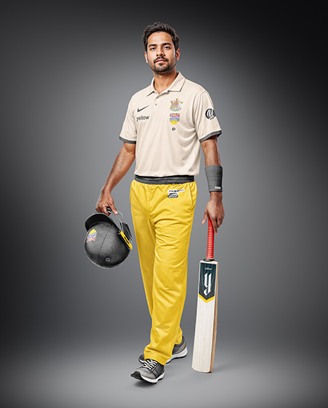 Indian Man Wearing Full Cricket Kit with Bat