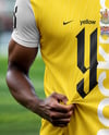 Soccer Player Wearing a Crew Neck Jersey and Shorts at the Stadium Mockup