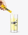 Matte Stick Sachet With Powder in a Hand & Water Glass Mockup