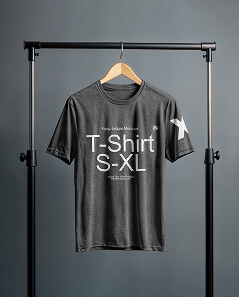 T-Shirt on a Wooden Hanger Against a Plain Background Mockup