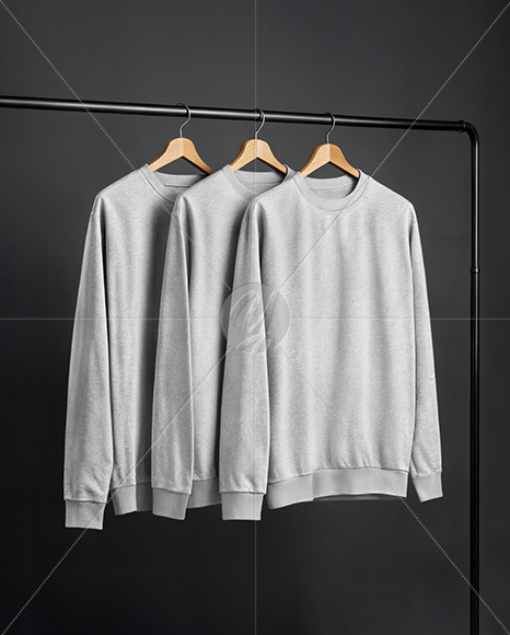Three Sweatshirts on a Black Rack Against a Plain Background Mockup