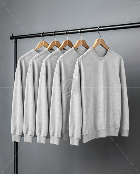 Five Sweatshirts on a Black Rack Against a Plain Background Mockup