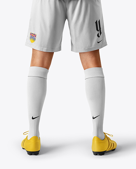 Man Wearing Soccer Jersey and Shorts Mockup